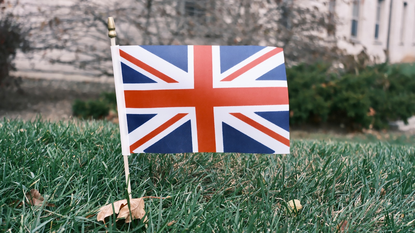 Union jack flag flying outside building at night